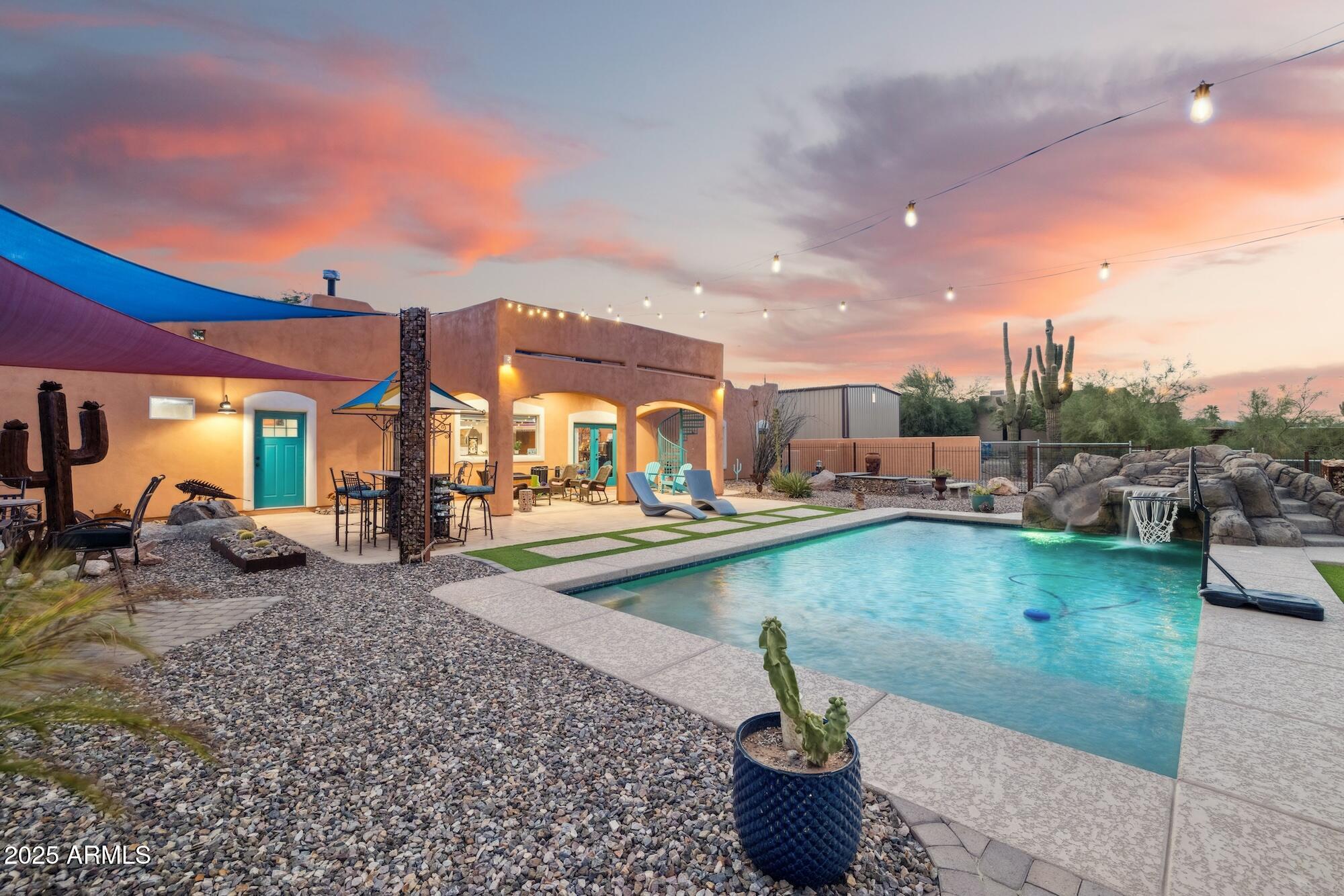 655 South Conestoga Road Apache Junction, AZ 85119 - Photo 12 of 79 a view of a swimming pool and lounge chairs