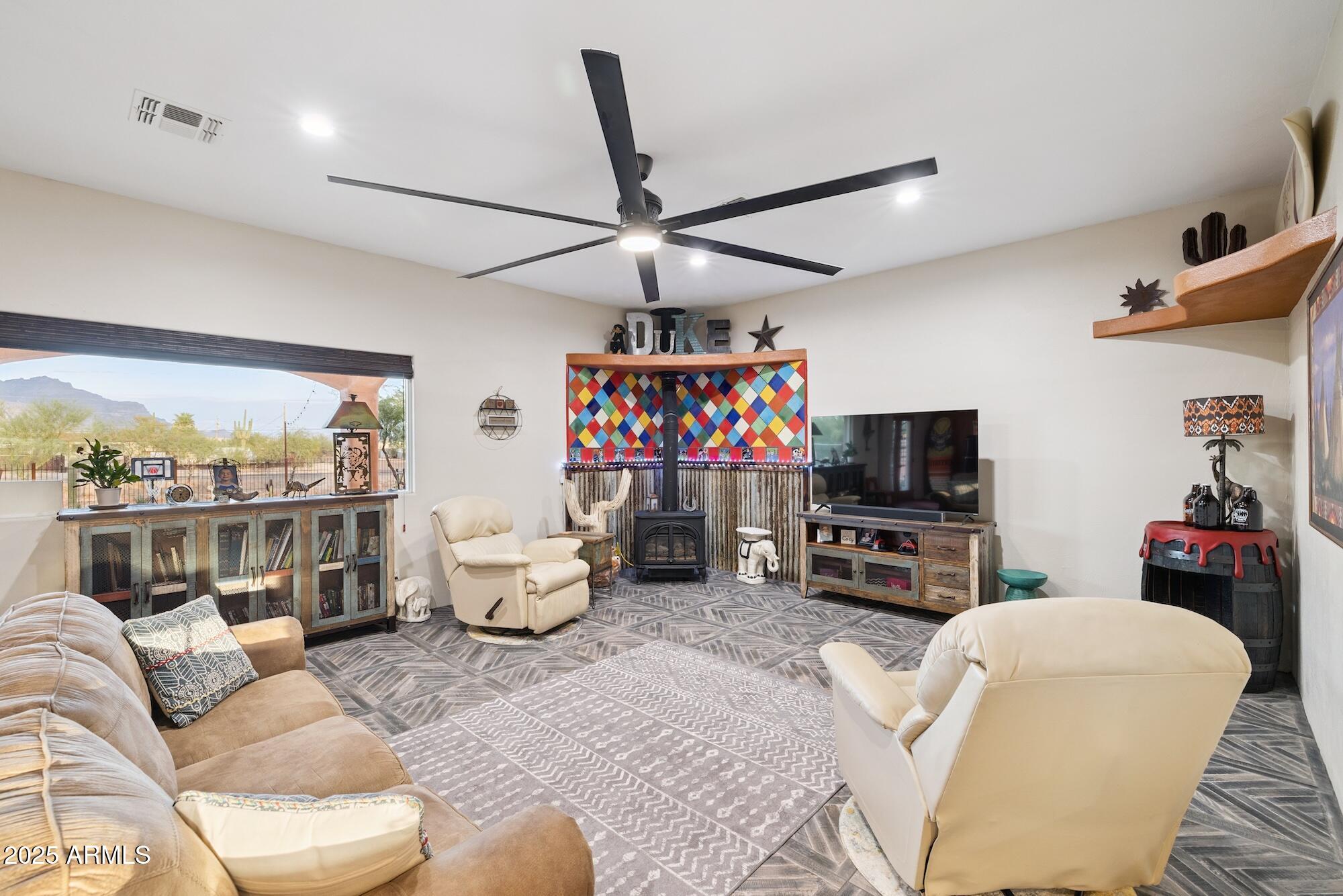 655 South Conestoga Road Apache Junction, AZ 85119 - Photo 34 of 79 a living room with furniture a flat screen tv and a large window