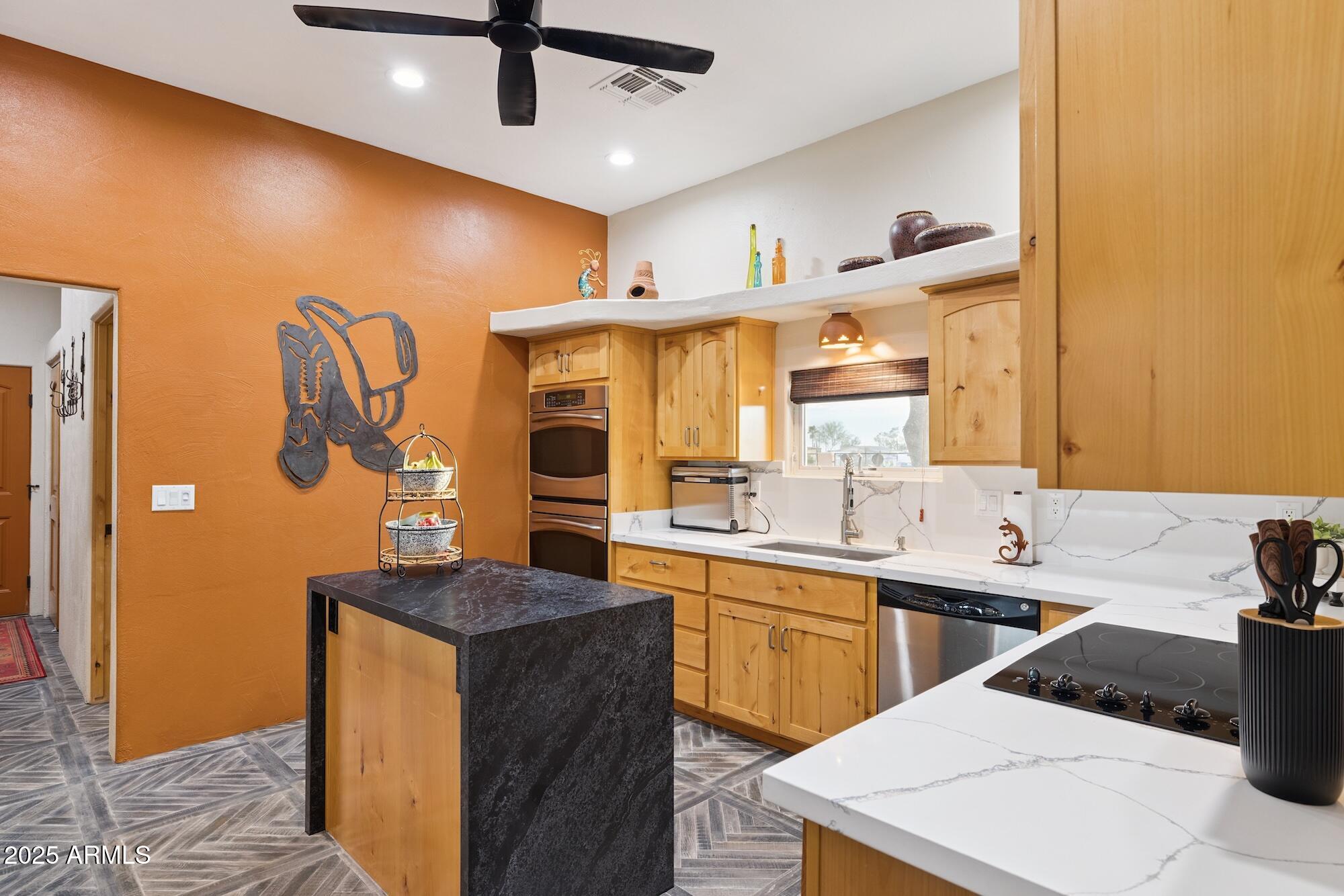 655 South Conestoga Road Apache Junction, AZ 85119 - Photo 41 of 79 a kitchen with stainless steel appliances kitchen island a sink and cabinets