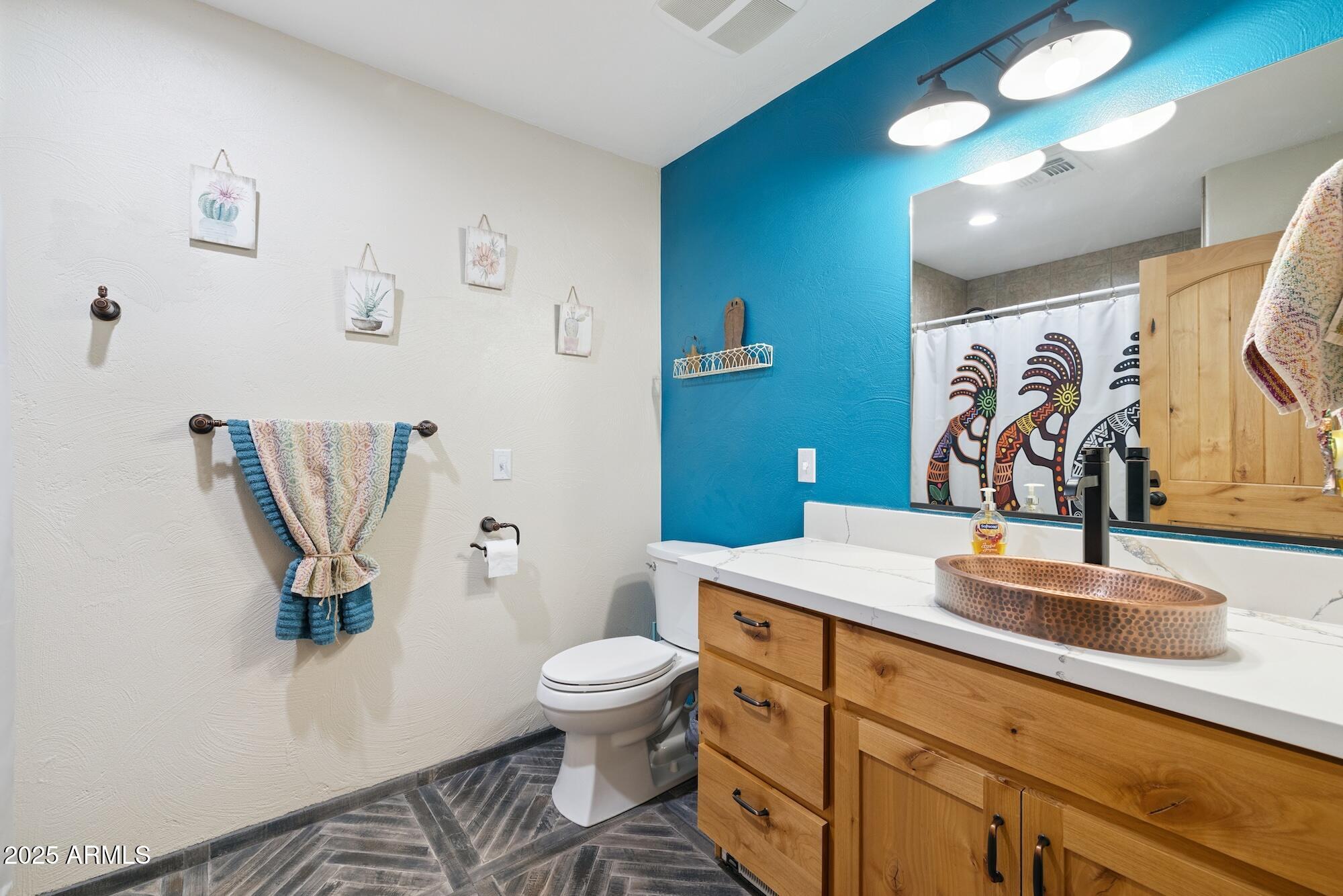 655 South Conestoga Road Apache Junction, AZ 85119 - Photo 48 of 79 a bathroom with a sink a toilet and mirror