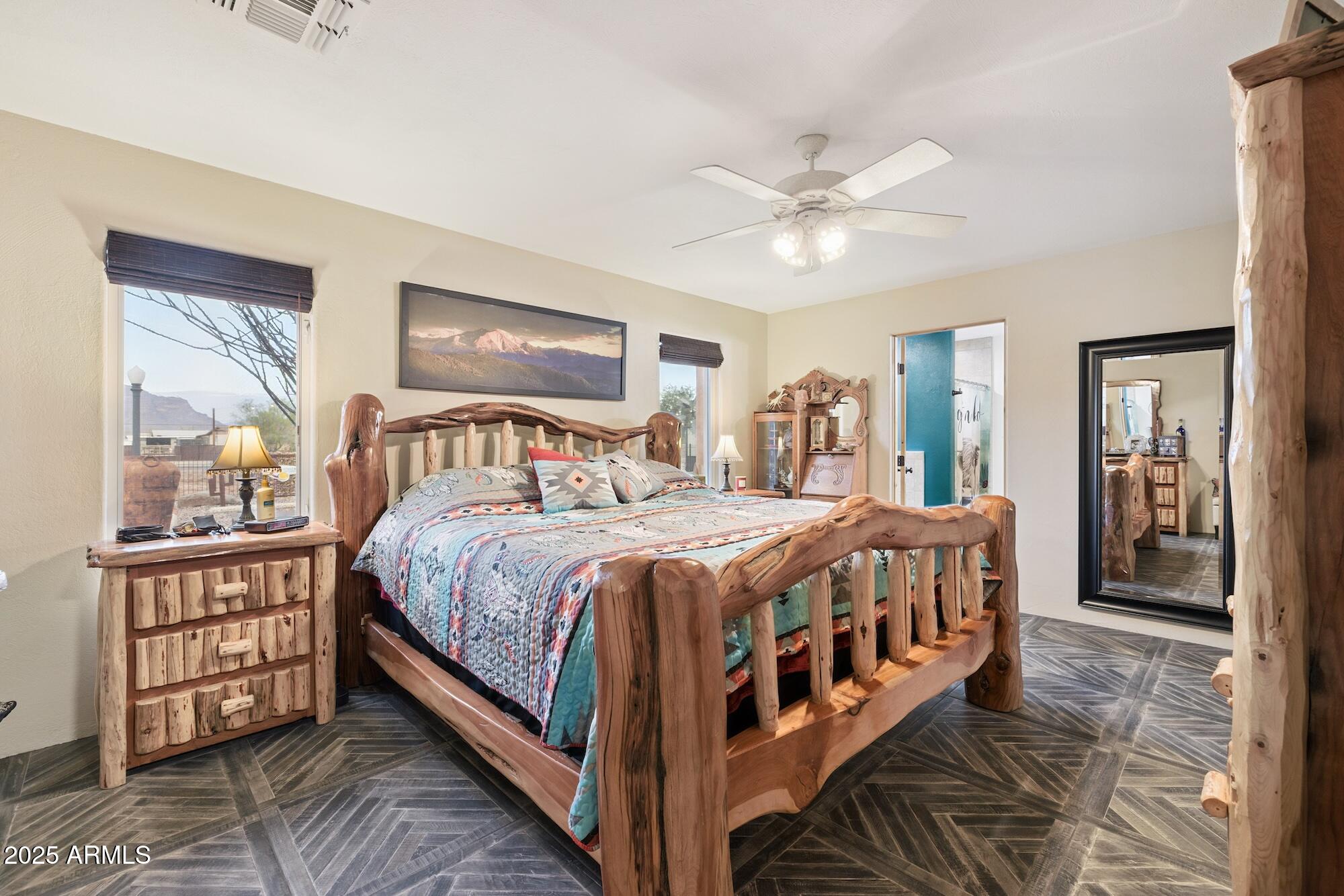 655 South Conestoga Road Apache Junction, AZ 85119 - Photo 53 of 79 a bedroom with a large bed and a chandelier