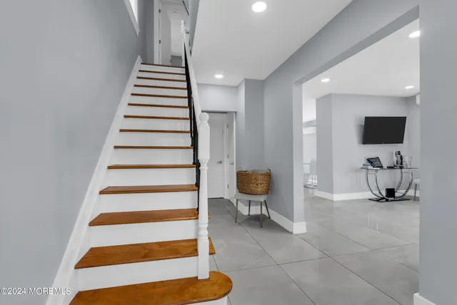 a view of entryway and hall with wooden floor