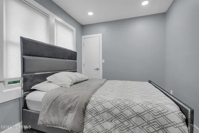 a bedroom with a bed and a window