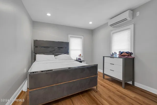 a room with a bed and a dresser