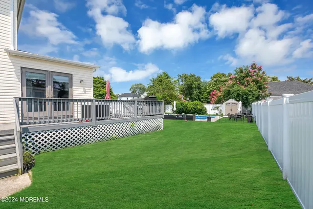 a view of a house with a yard deck and a garden
