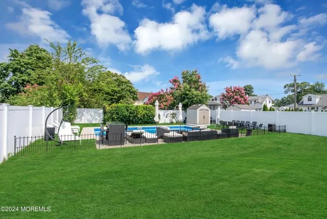 a view of a house with a yard and sitting area
