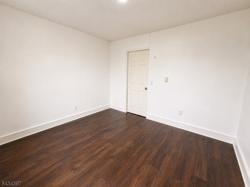 207 Old Chimney Ridge Road, Unit L Montague, NJ 07827 - Photo 9 of 14 a view of an empty room with wooden floor