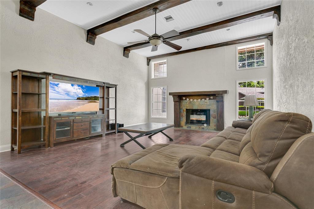 11056 Clipper Court Windermere, FL 34786 - Photo 7 of 18 a living room with furniture a fireplace and a flat screen tv