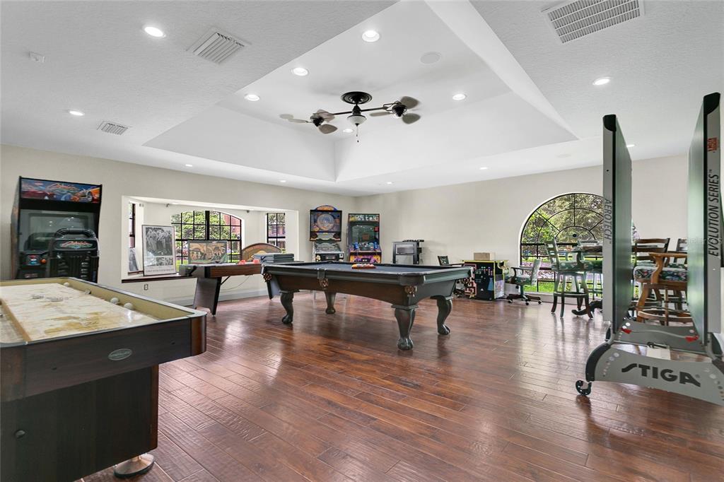 11056 Clipper Court Windermere, FL 34786 - Photo 10 of 18 a living room with furniture a pool table and a bookshelf