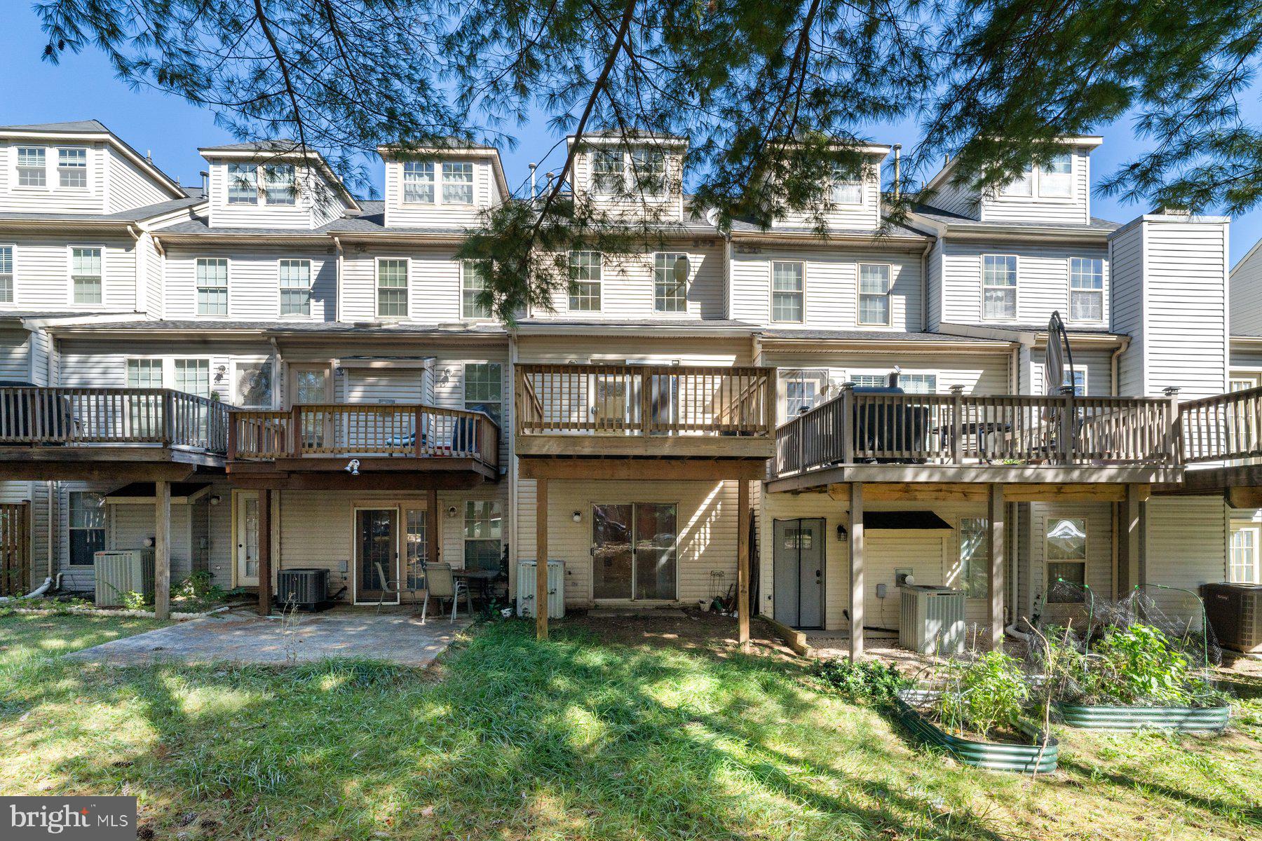 11 Bank Spring Court Owings Mills, MD 21117 - Photo 28 of 35 a front view of a residential apartment building with a yard