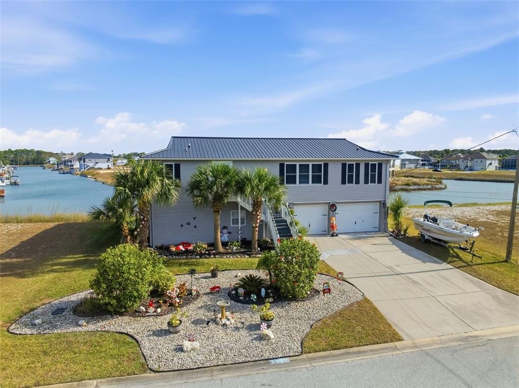 3366 Bluefish Drive Hernando Beach, FL 34607 - Photo 37 of 75 a view of a house with pool garden and lake view