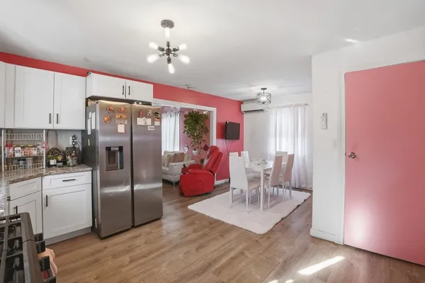 a kitchen with granite countertop a refrigerator and a stove
