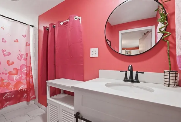 a bathroom with a sink mirror and vanity