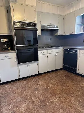 a kitchen with granite countertop a stove and a sink