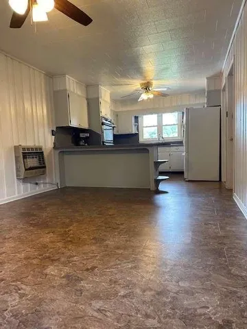 a kitchen with stainless steel appliances a refrigerator and a stove