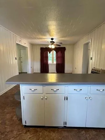 a view of a kitchen with cabinets and wooden floor