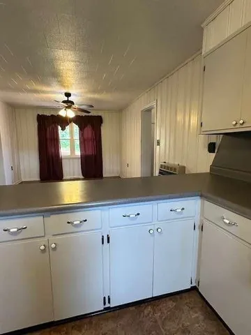 a kitchen with cabinets and white appliances