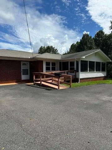 a front view of building with garage and a fountain