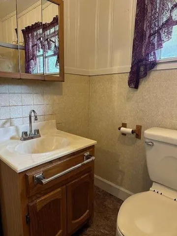 a bathroom with a toilet sink and shower