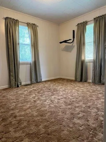 a view of a room with a fireplace and window