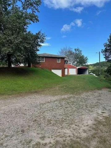 a large brick building with a yard in front of it