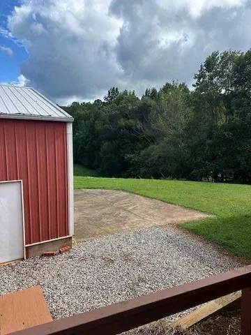 a view of house with backyard