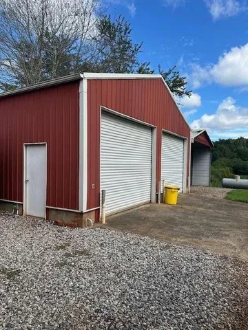 a view of a houses with yard and mountain view in back