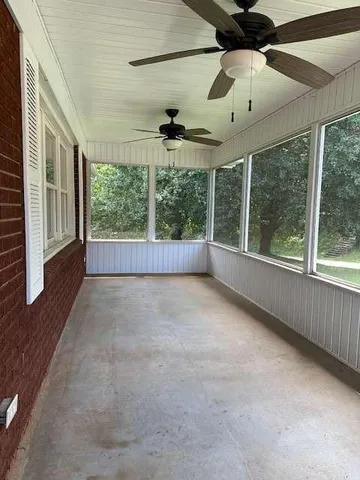 an empty room with windows and outdoor view