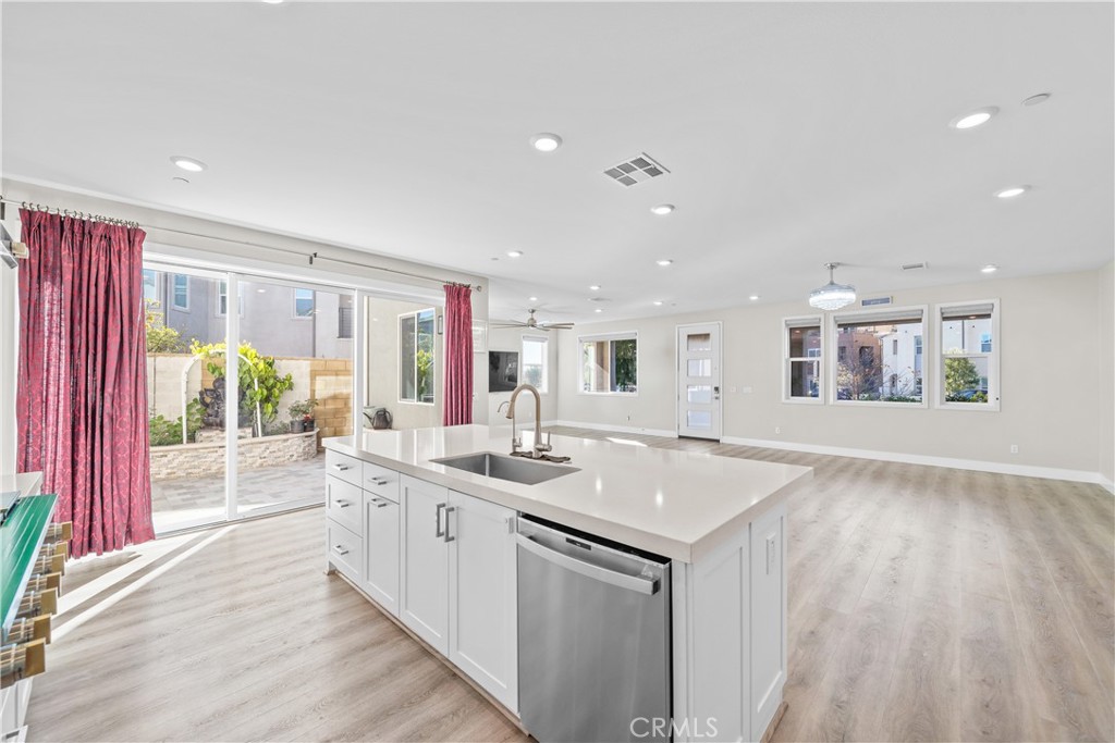 124 Zawn Irvine, CA 92618 - Photo 16 of 56 a view of a kitchen with kitchen island granite countertop a sink and dishwasher with wooden floor