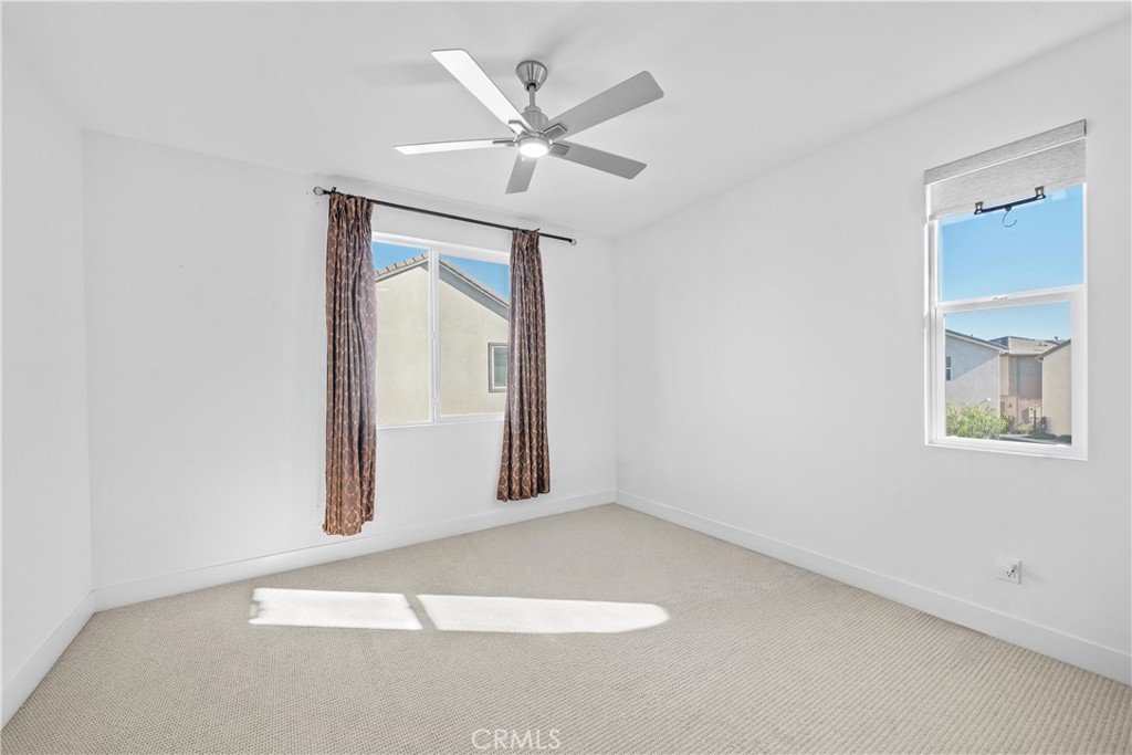 124 Zawn Irvine, CA 92618 - Photo 29 of 56 an empty room with a window and a ceiling fan