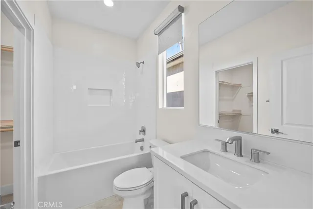 a view of a livingroom with a ceiling fan and window
