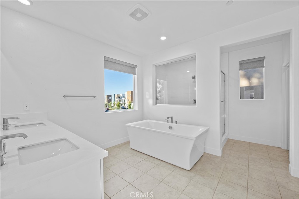 124 Zawn Irvine, CA 92618 - Photo 37 of 56 a spacious bathroom with a sink a mirror and a bathtub