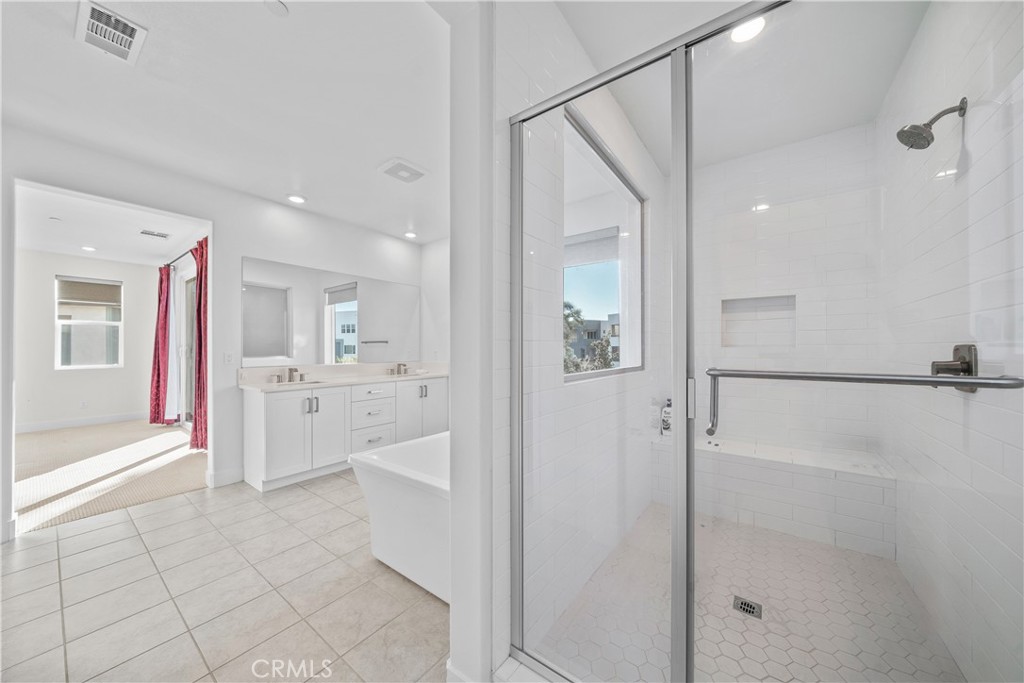 124 Zawn Irvine, CA 92618 - Photo 41 of 56 a large white bathroom with a glass shower door and a sink