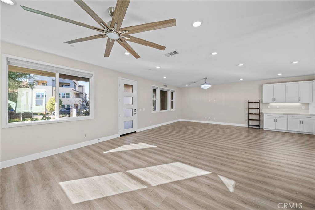 124 Zawn Irvine, CA 92618 - Photo 9 of 56 a view of an empty room with a window and kitchen view