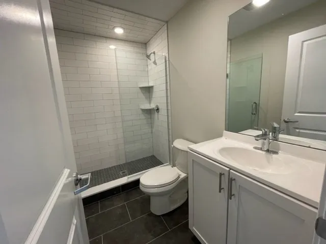 a bathroom with a sink toilet and shower