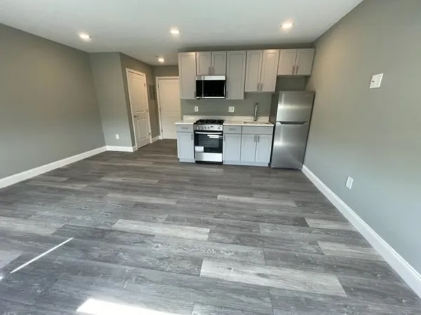 a kitchen with granite countertop a refrigerator and a stove