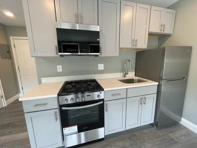 a kitchen with a stove and a microwave