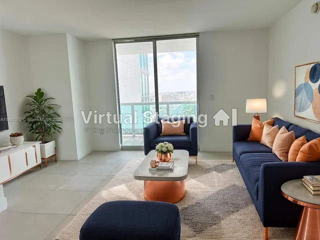 a living room with furniture and a potted plant
