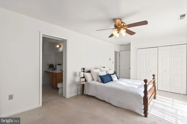a bedroom with a bed and a ceiling fan