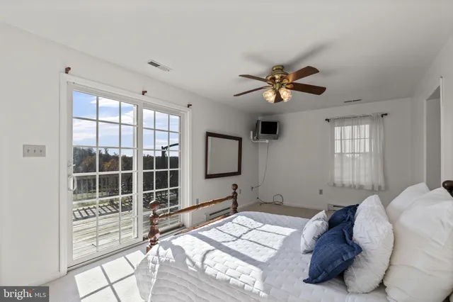 a bedroom with bed and glass door
