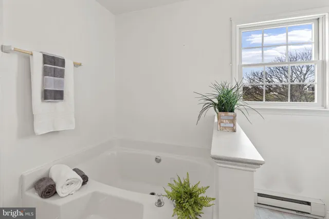 a white bath tub sitting next to a window