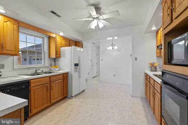 a large kitchen with cabinets and stainless steel appliances