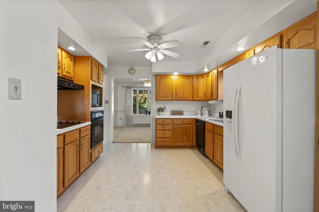 a kitchen with stainless steel appliances a refrigerator sink stove microwave and cabinets
