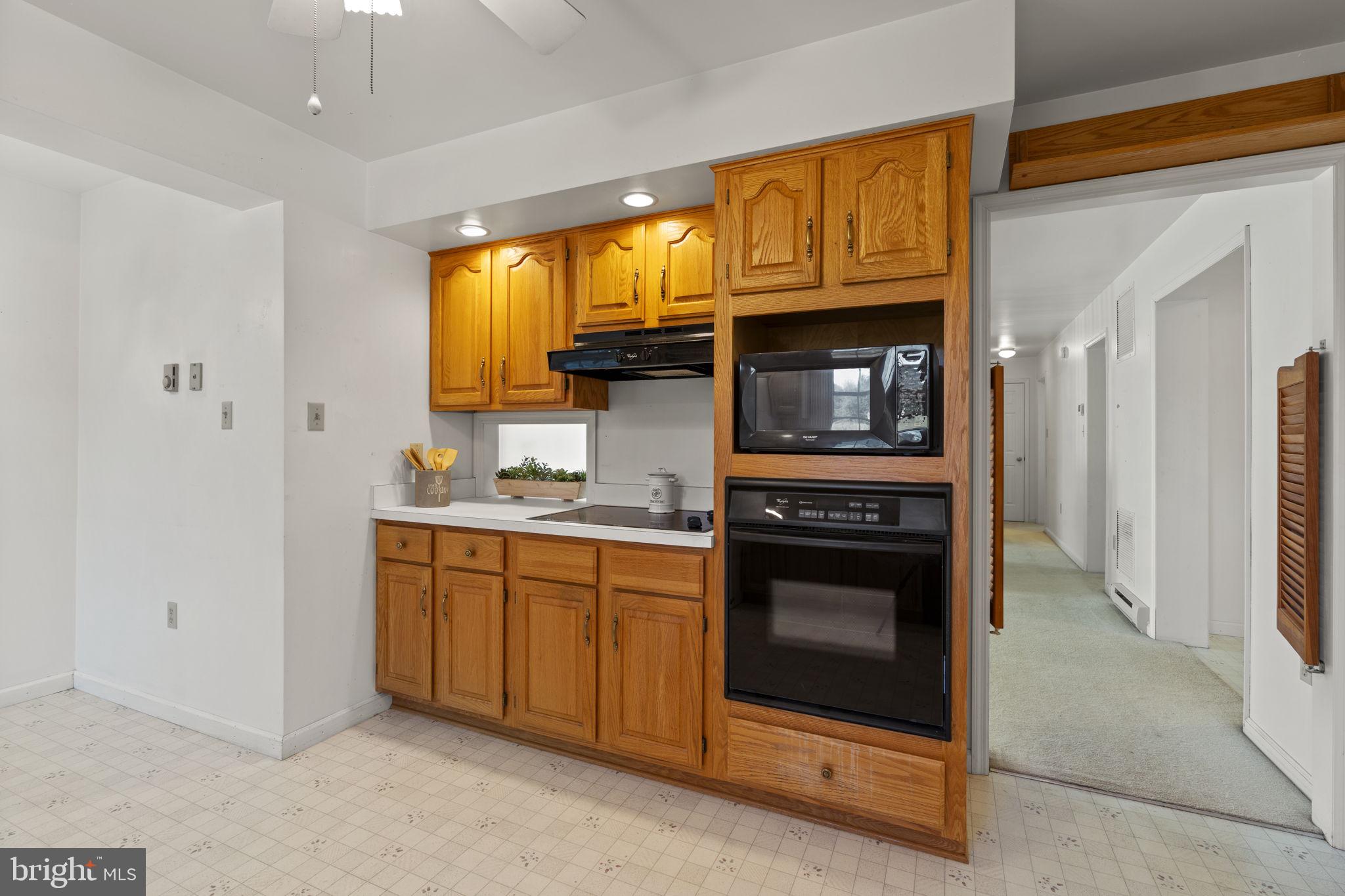 5715 Emory Road Upperco, MD 21155 - Photo 7 of 43 a kitchen with stainless steel appliances granite countertop a stove and a refrigerator