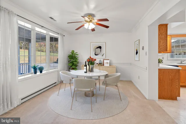 a dining room with furniture a window and a chandelier