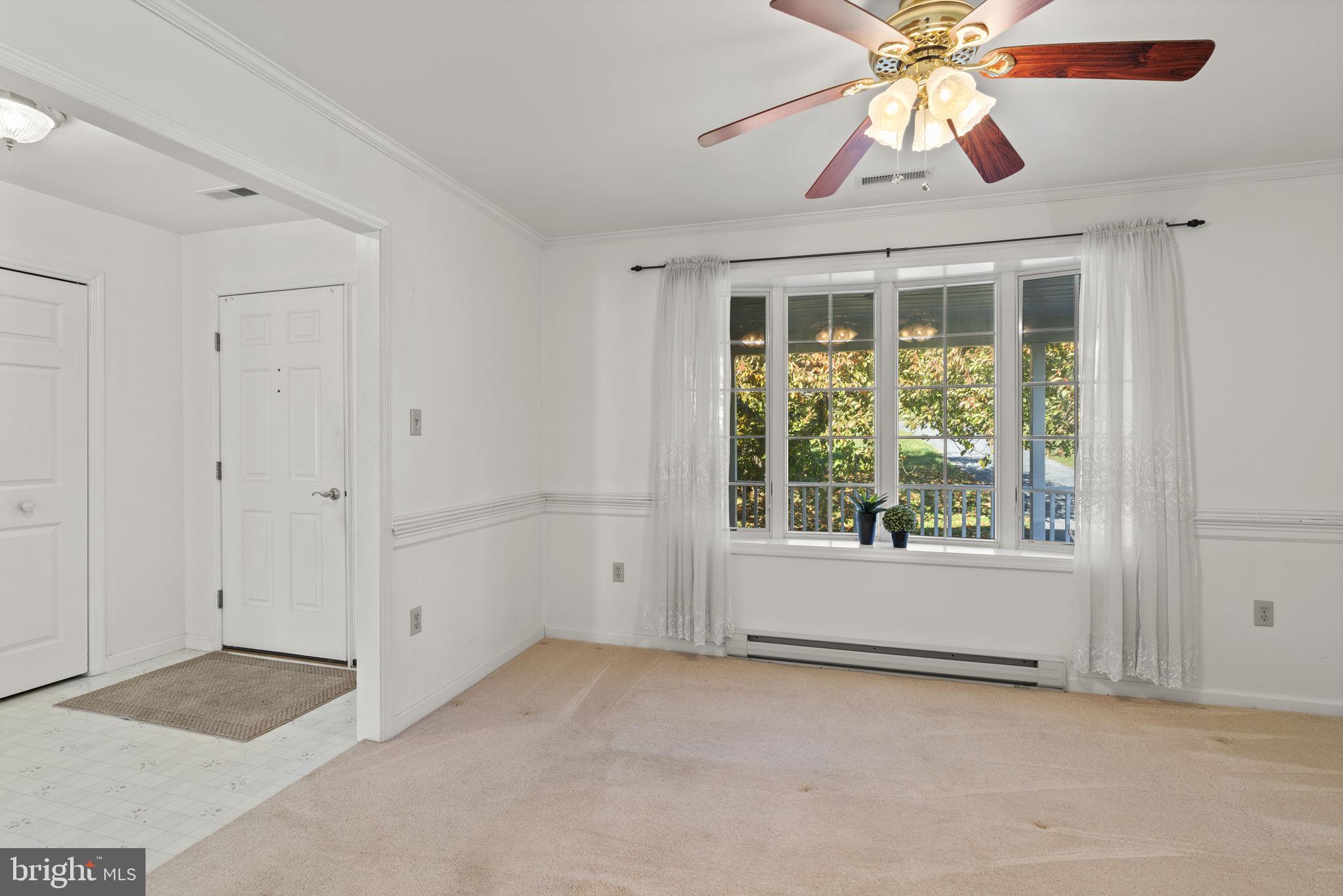 5715 Emory Road Upperco, MD 21155 - Photo 9 of 43 an empty room with a window and a chandelier fan
