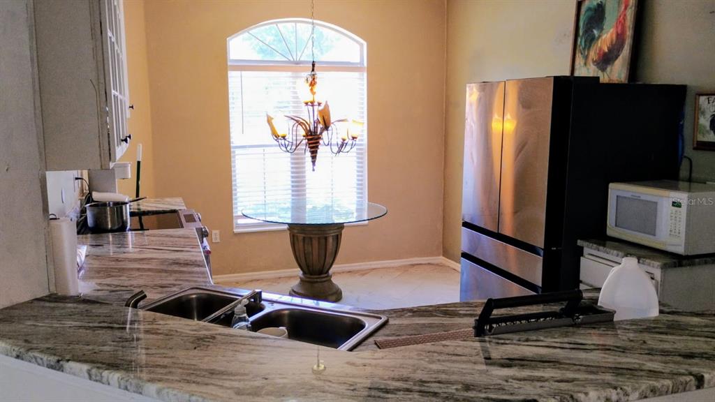 11591 Southwest 78th Avenue Ocala, FL 34476 - Photo 11 of 23 a room with table and couch