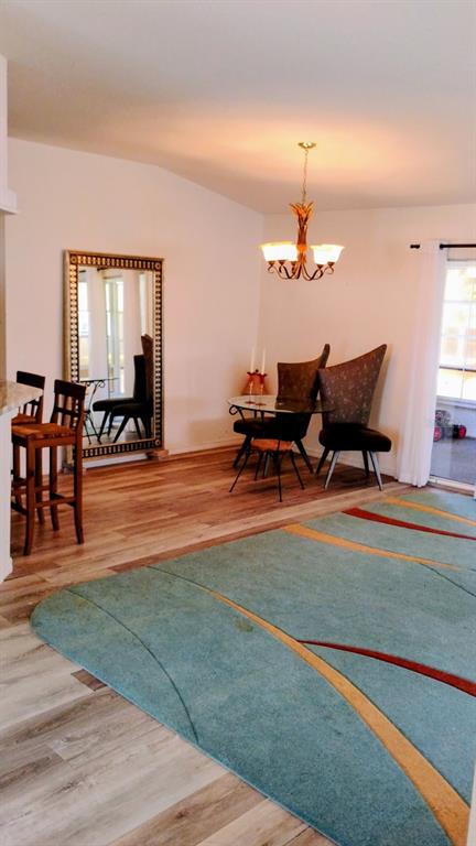 11591 Southwest 78th Avenue Ocala, FL 34476 - Photo 8 of 23 a living room with furniture and a chandelier