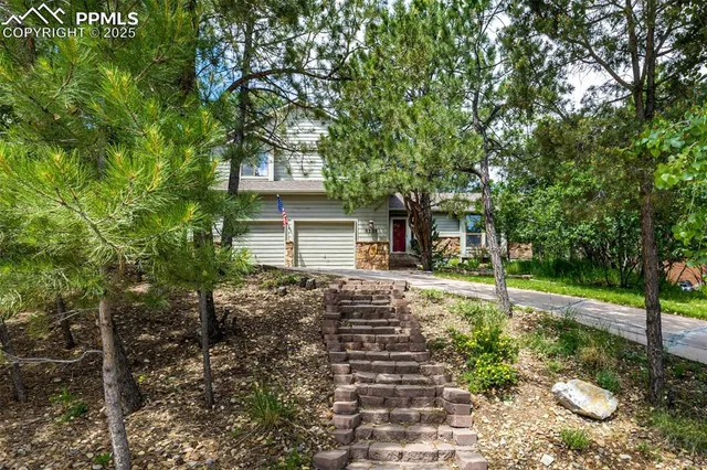 a view of a house with yard and tree s