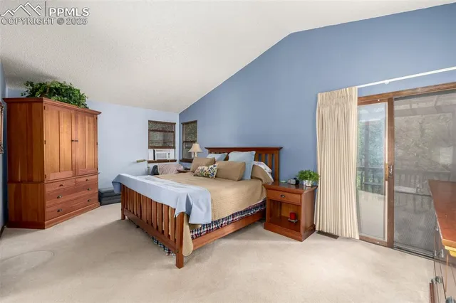 a spacious bedroom with a bed and a cabinets